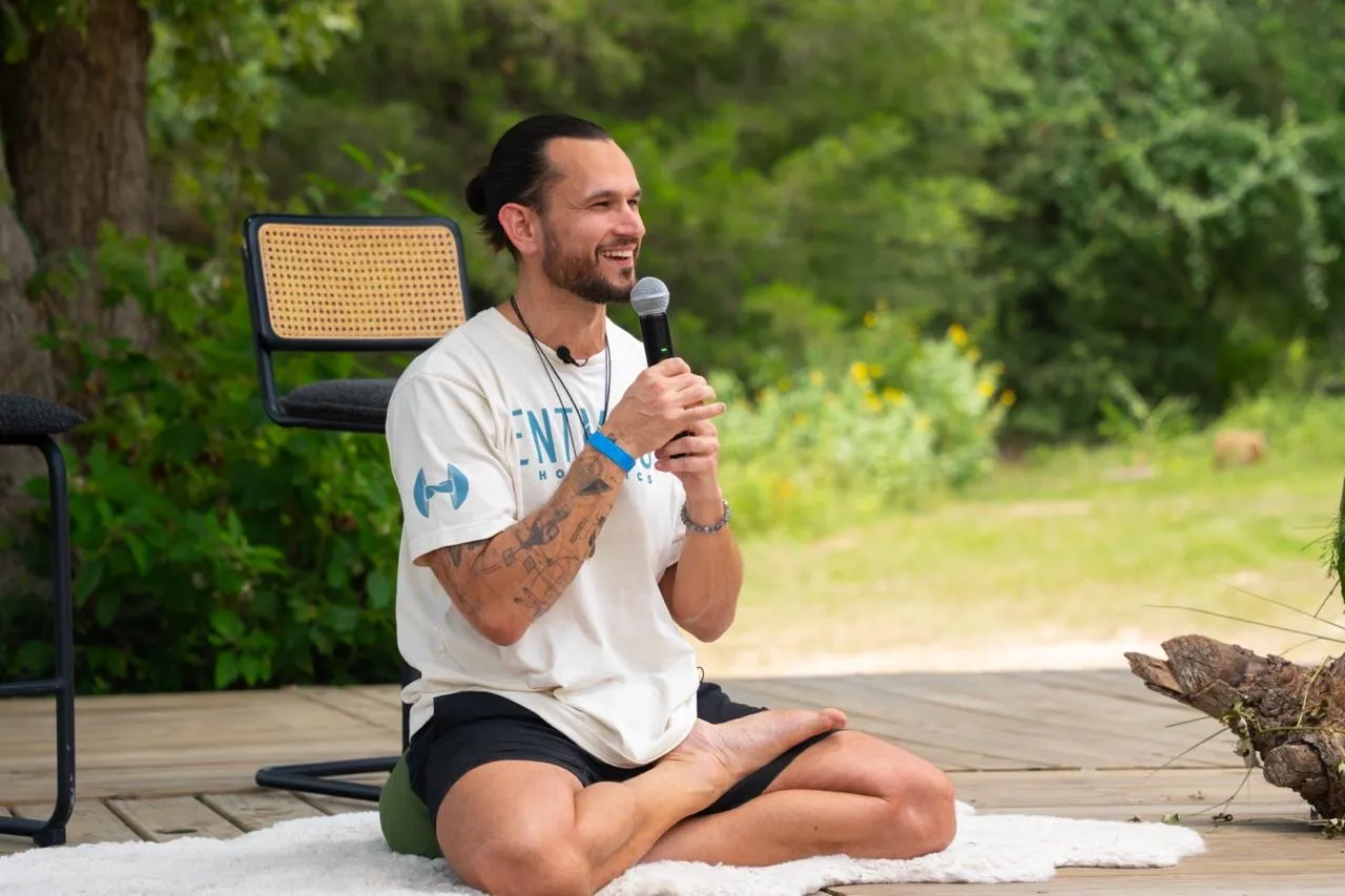 Austin teaching outdoors with a microphone
